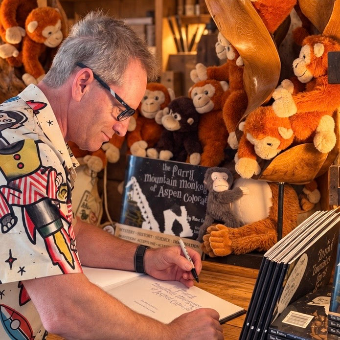 Vince signing a Furry Mountain Monkeys book before packing.
